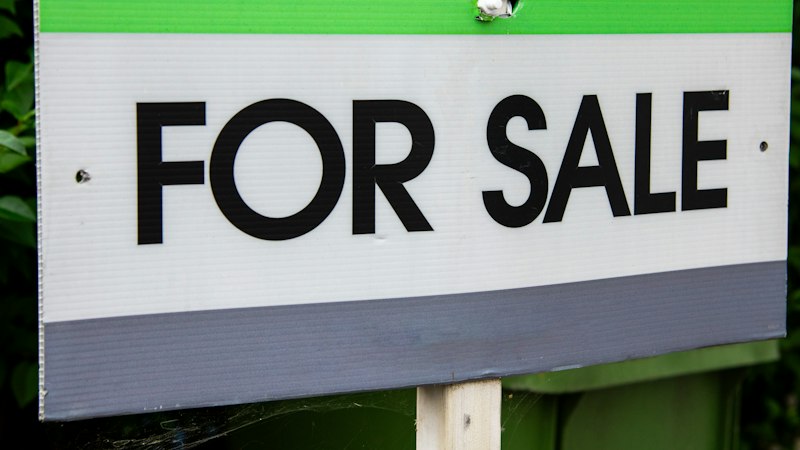 For Sale sign in a front yard, the moment flooring choices start to affect home value