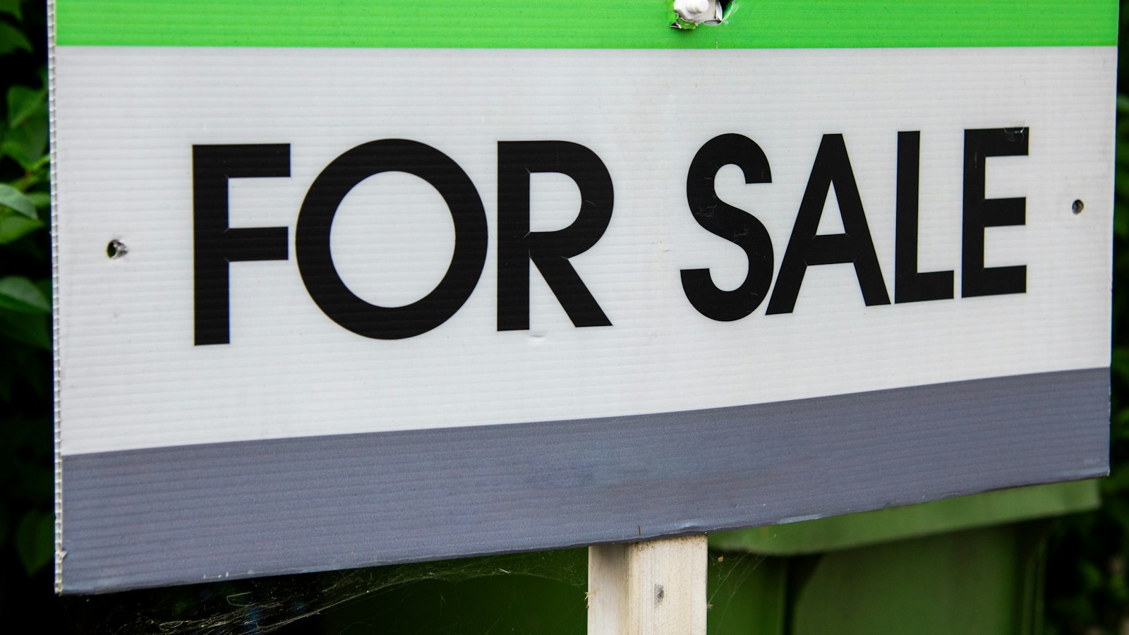 For Sale sign in a front yard, the moment flooring choices start to affect home value