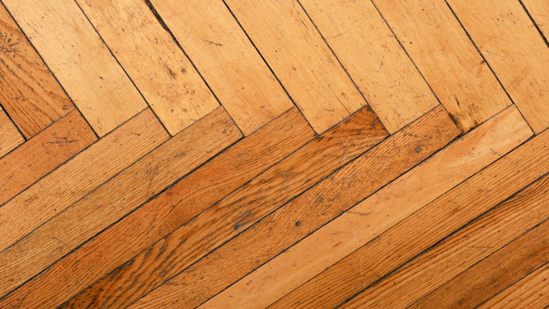 Warm oak hardwood floor laid in a classic herringbone pattern
