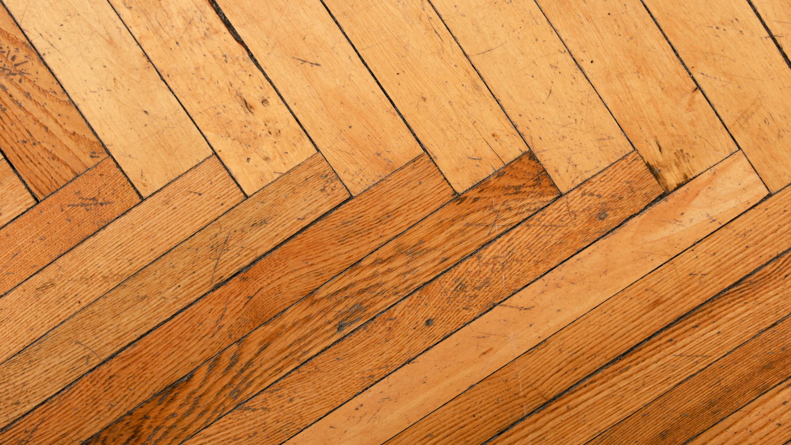 Warm oak hardwood floor laid in a classic herringbone pattern