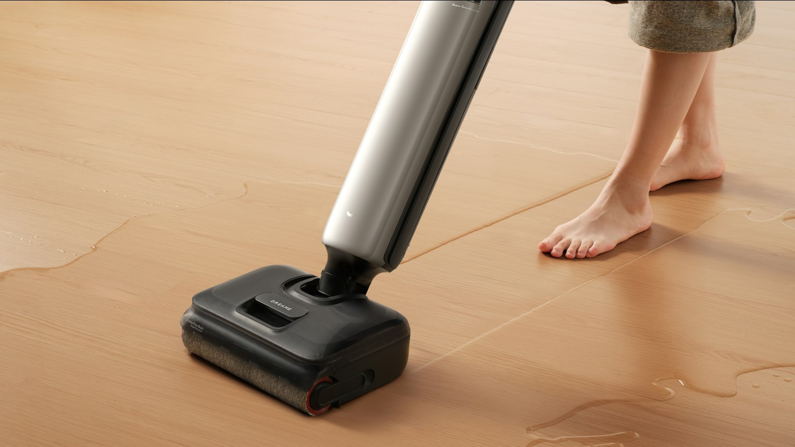 Wet-dry floor cleaner picking up spilled water from a wood-look luxury vinyl plank floor
